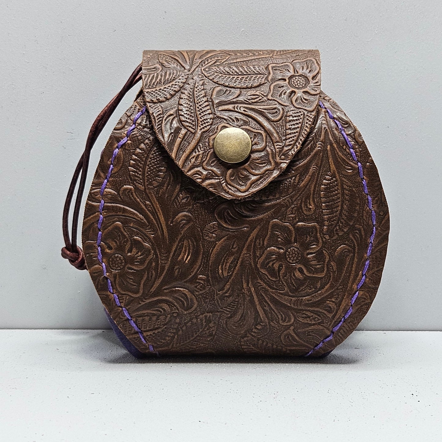 brown leather pouch with flowers