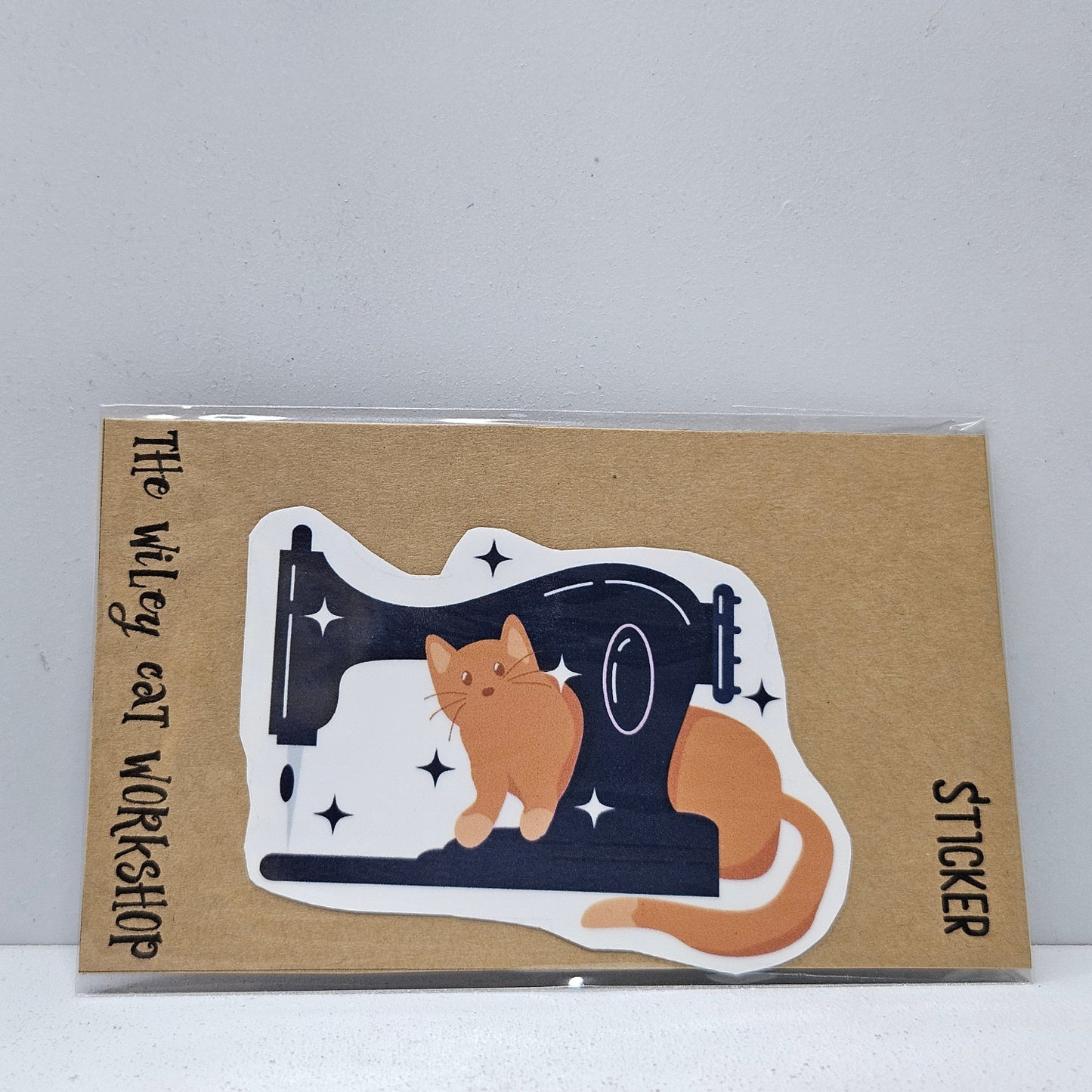 Orange Cat on the Sewing Machine Vinyl Sticker