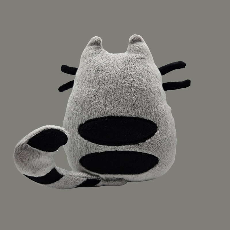Plush toy with cat-like design on a gray background