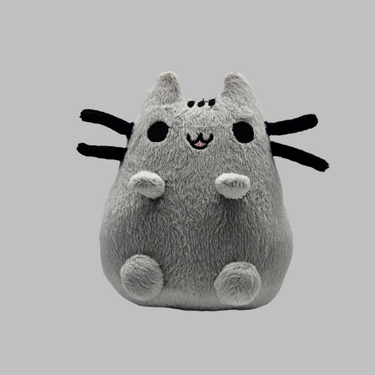 Plush toy resembling a cat with black accents on a gray background