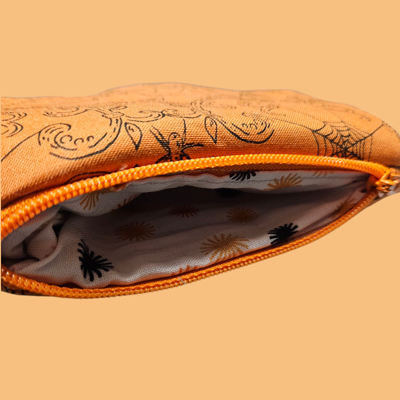 Orange pouch with zipper on a matching background
