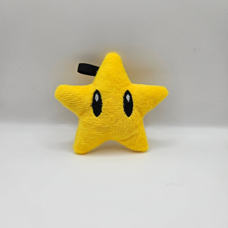 Yellow star-shaped plush toy with black details on a white background