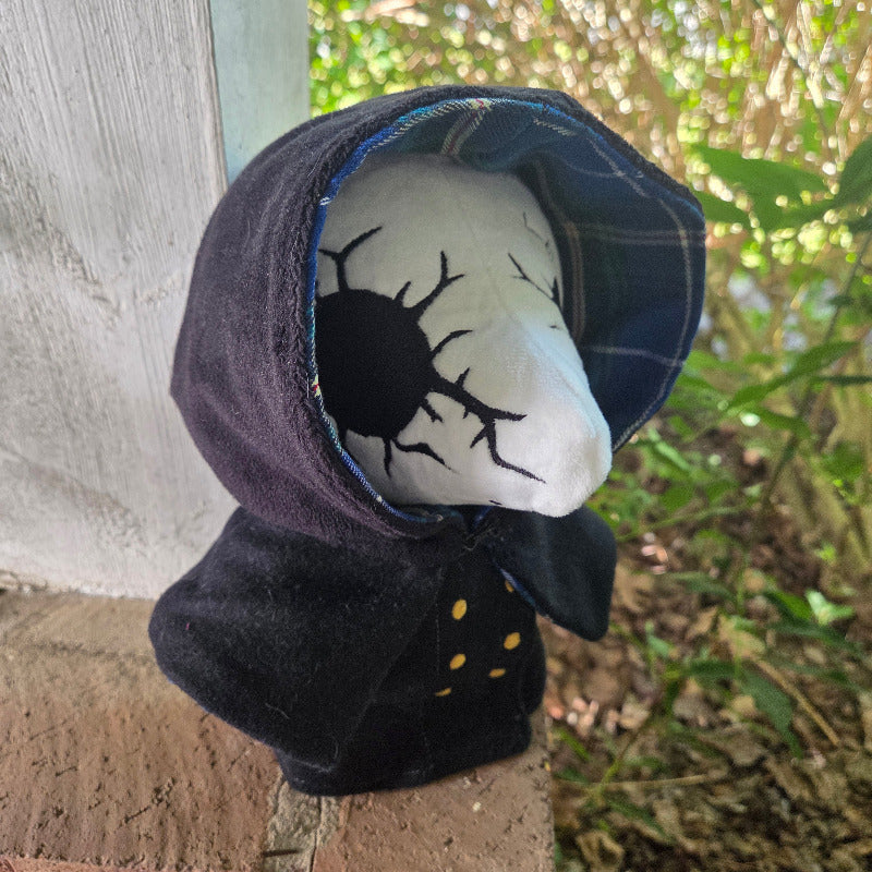 Plush toy with a face design on a textured surface