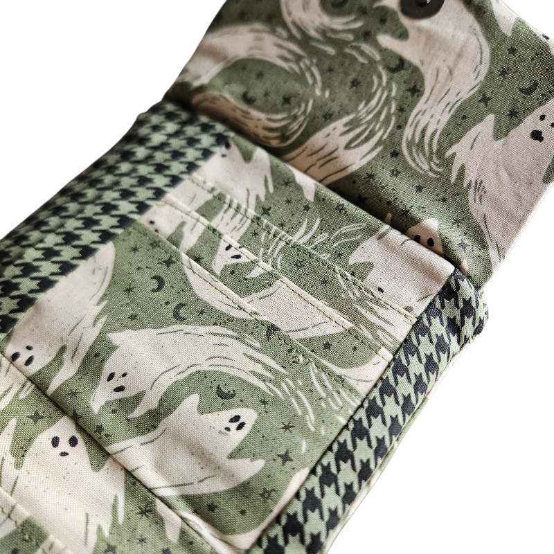 Folded fabric with ghost pattern on a green background