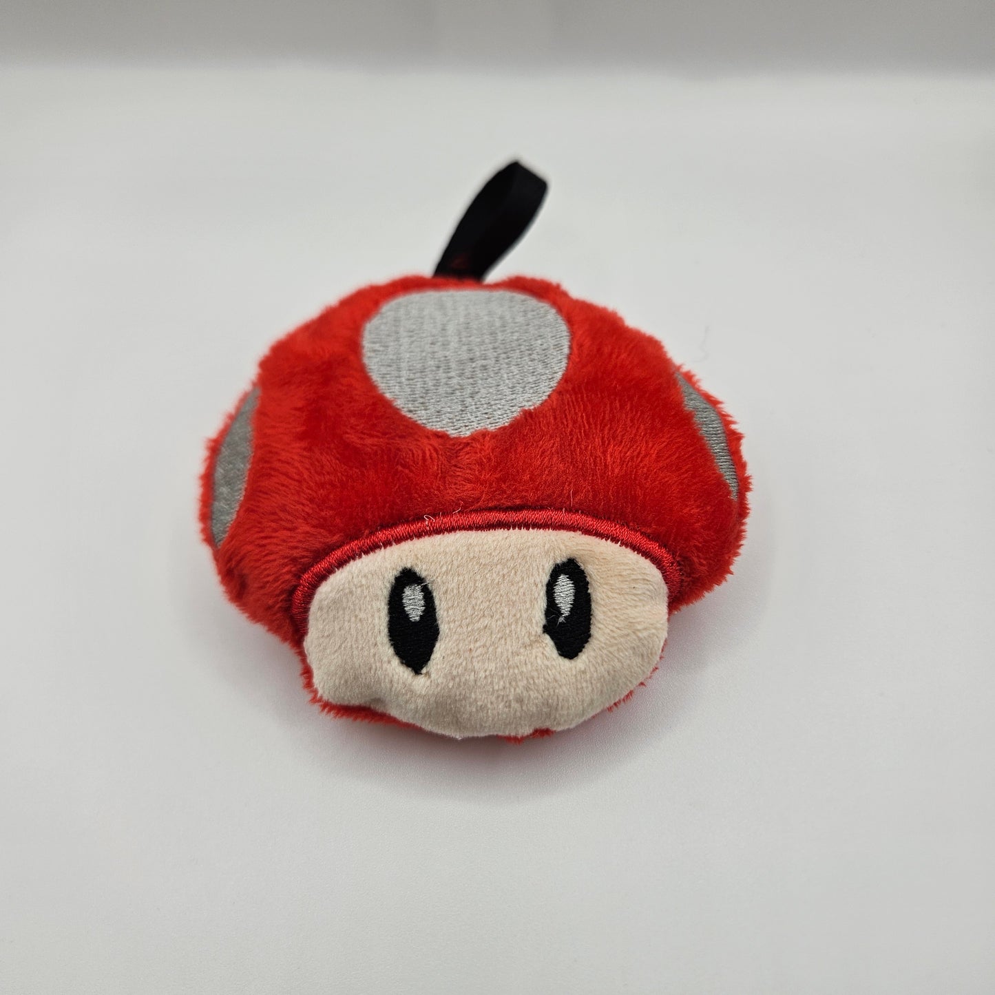Plush toy resembling a mushroom on a white background