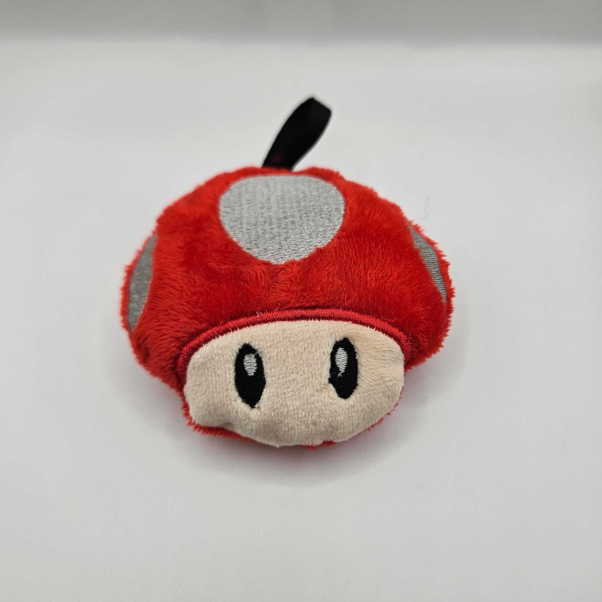 Plush toy resembling a mushroom on a white background