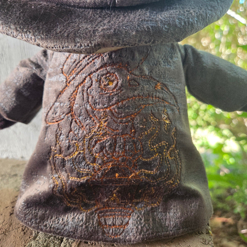 Close-up of a textured surface with intricate patterns, possibly leather or fabric, against a natural background.