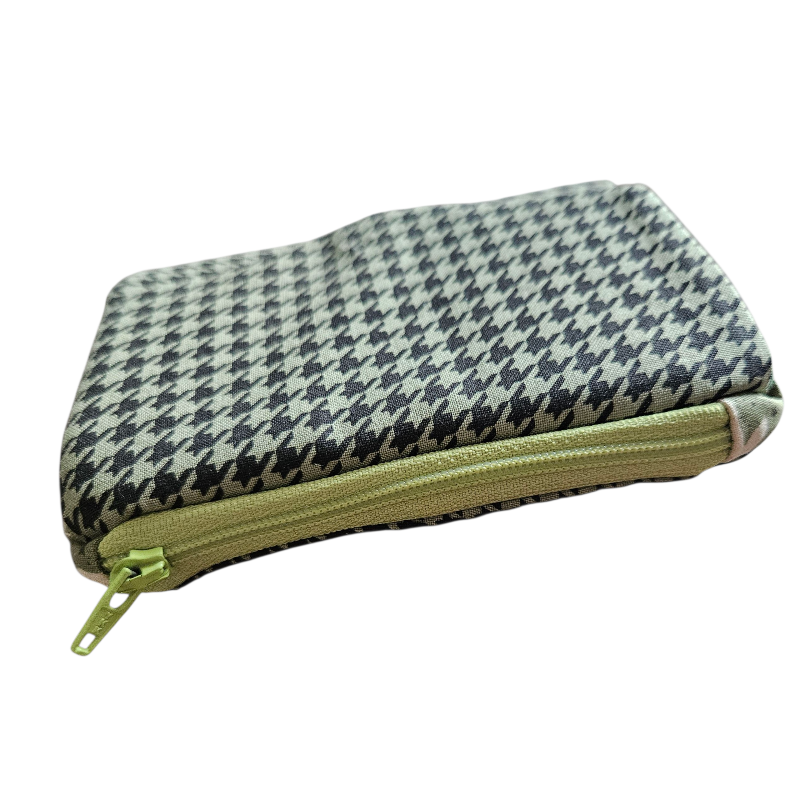 Houndstooth patterned pouch with a green zipper on a white background