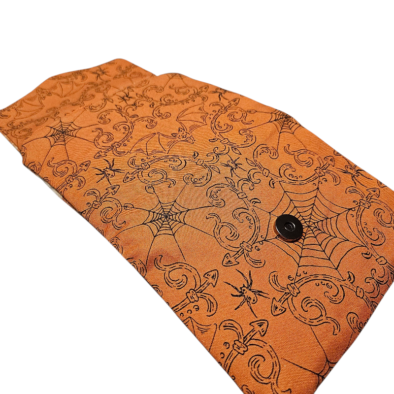Orange fabric with Halloween-themed pattern on a white background