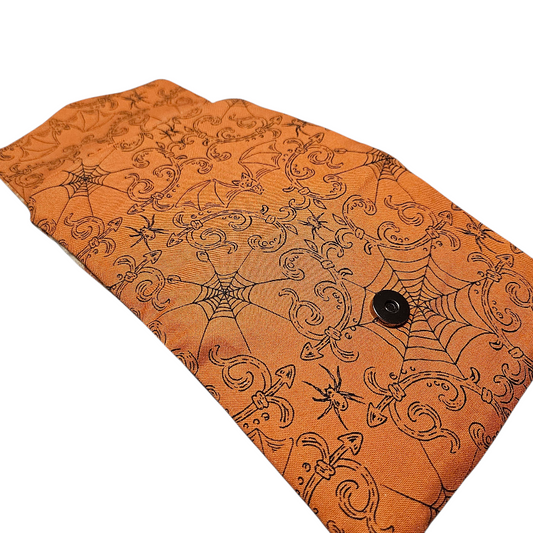 Orange fabric with Halloween-themed pattern on a white background