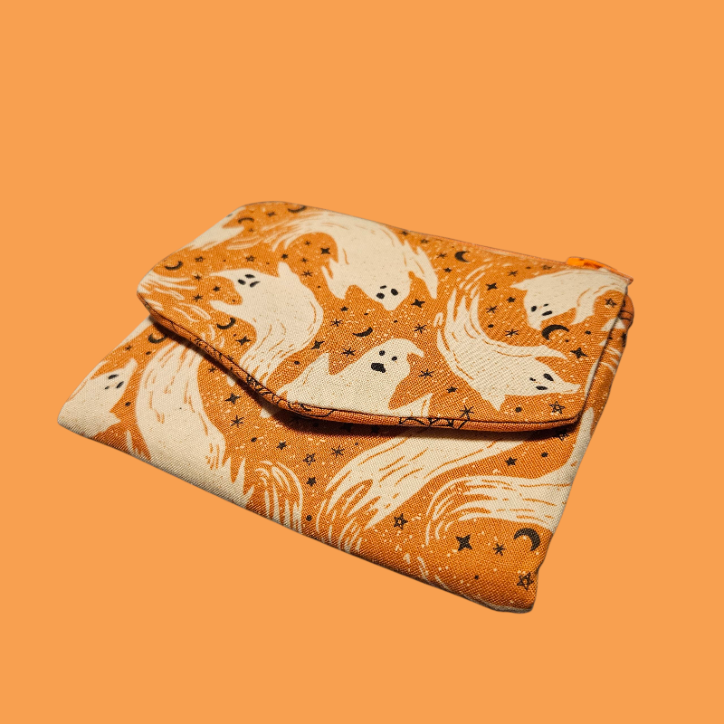 Fabric pouch with ghost pattern on an orange background