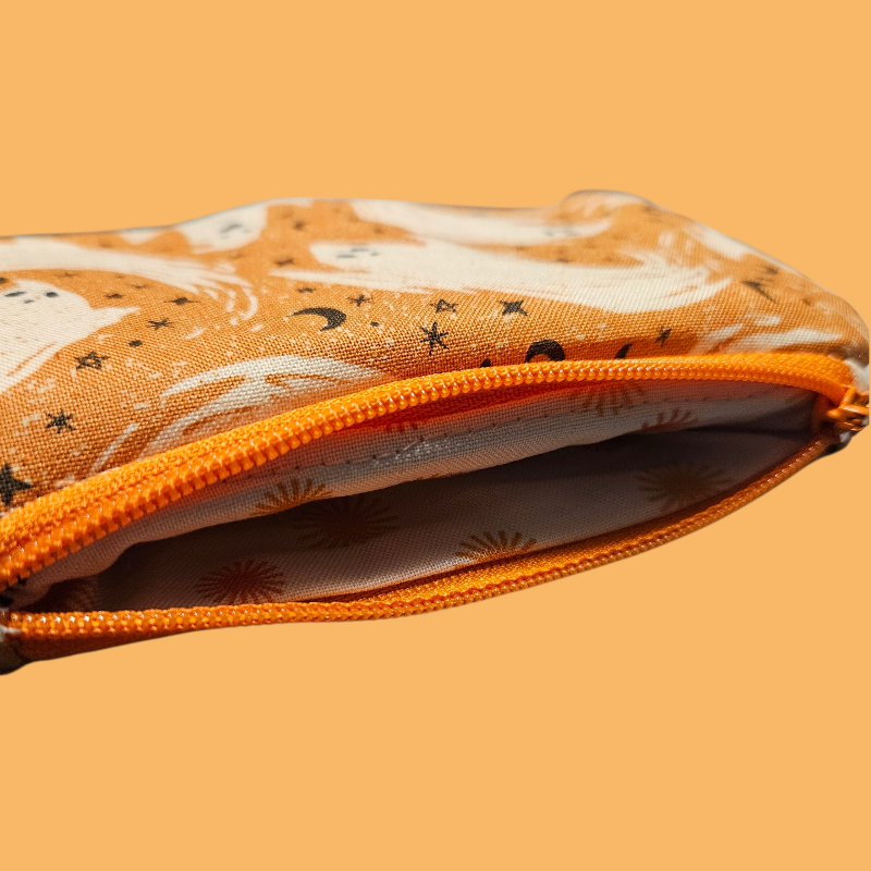 Zipped pouch with fox pattern on an orange background