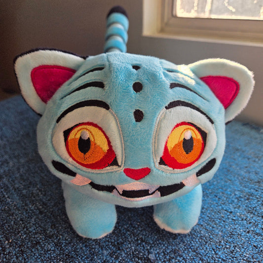 Plush toy tiger on a blue carpet