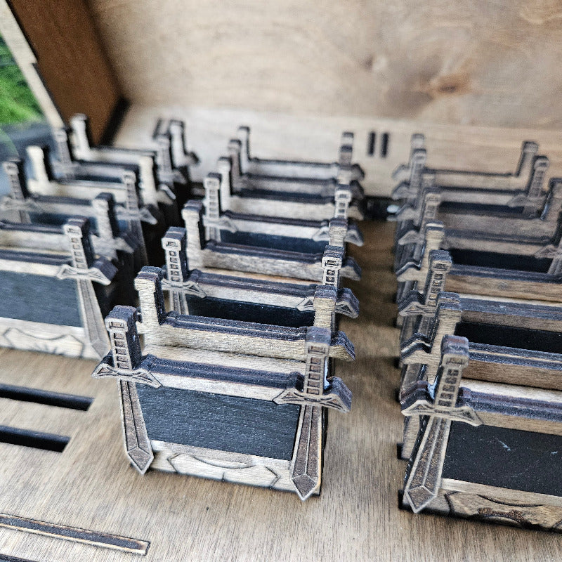 Stacks of small boxes with sword designs on a wooden surface