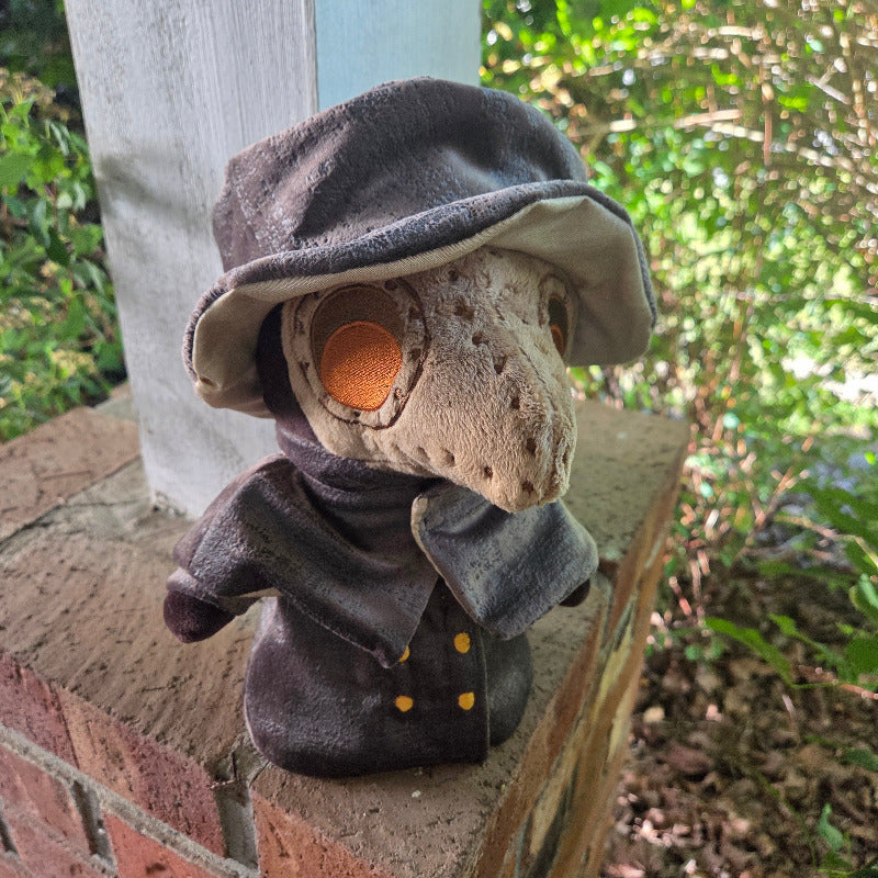Plush toy resembling a character with a hat on a ledge outdoors