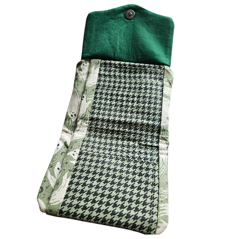 Folded fabric with green top and patterned bottom on a white background