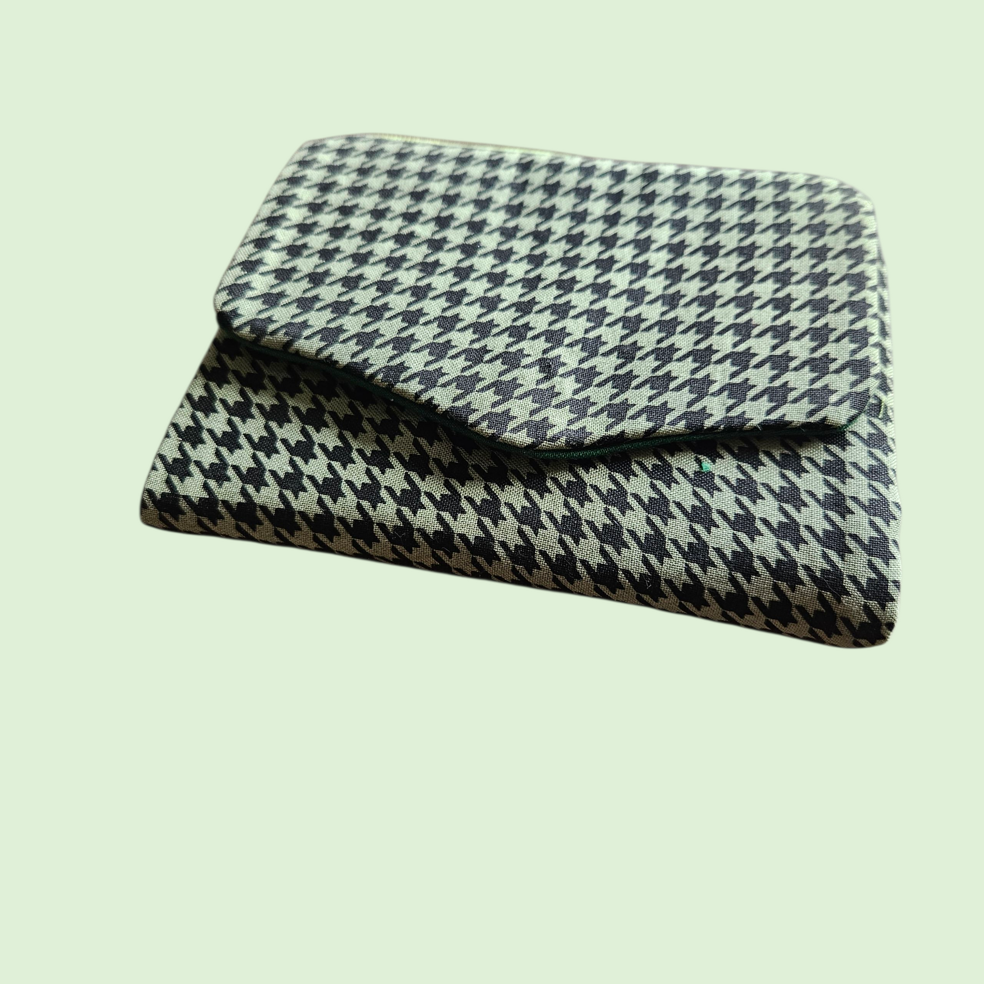 Houndstooth patterned blanket on a light green background